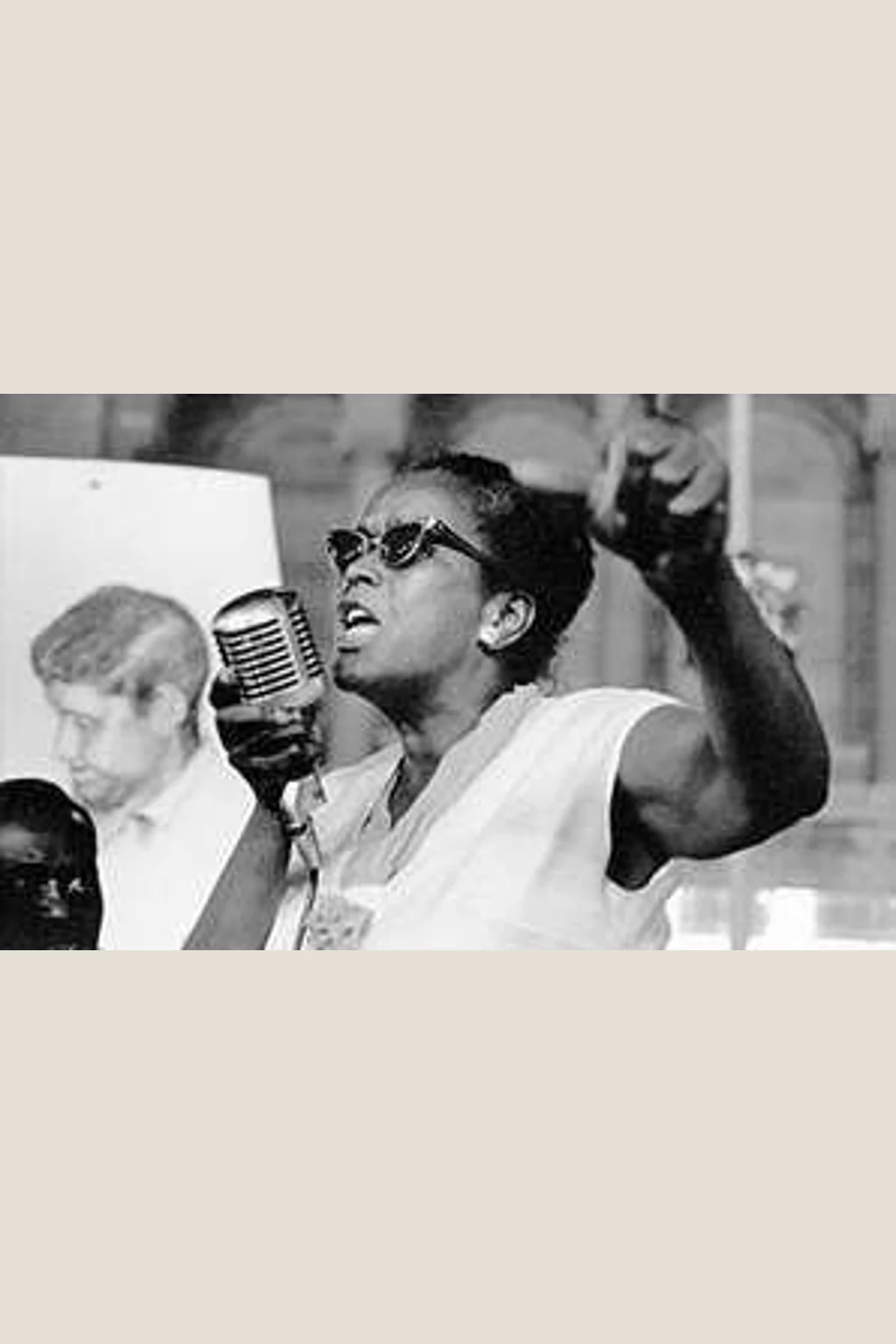 Ella Baker speaking into a microphone with one arm raised in an archival photograph supplied by the Ella Baker Center for Human Rights.